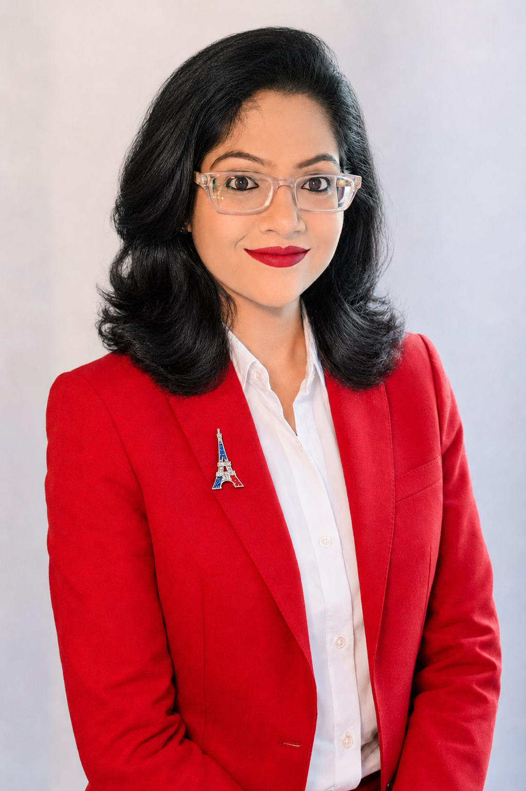 Dr. Annie Gupta in a red professional suit